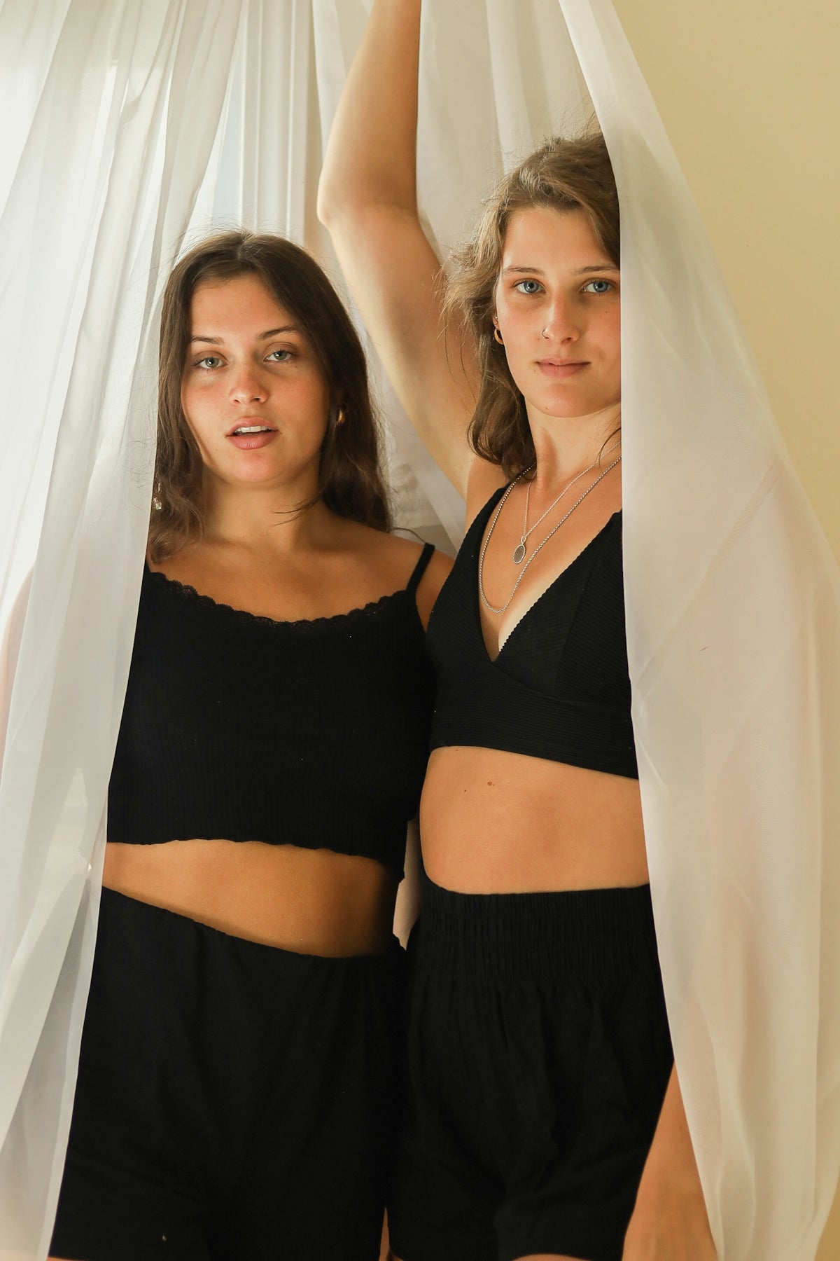 2 women in black tank top and black skirt