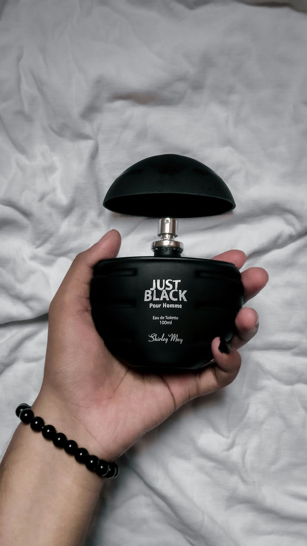person holding black calvin klein perfume bottle