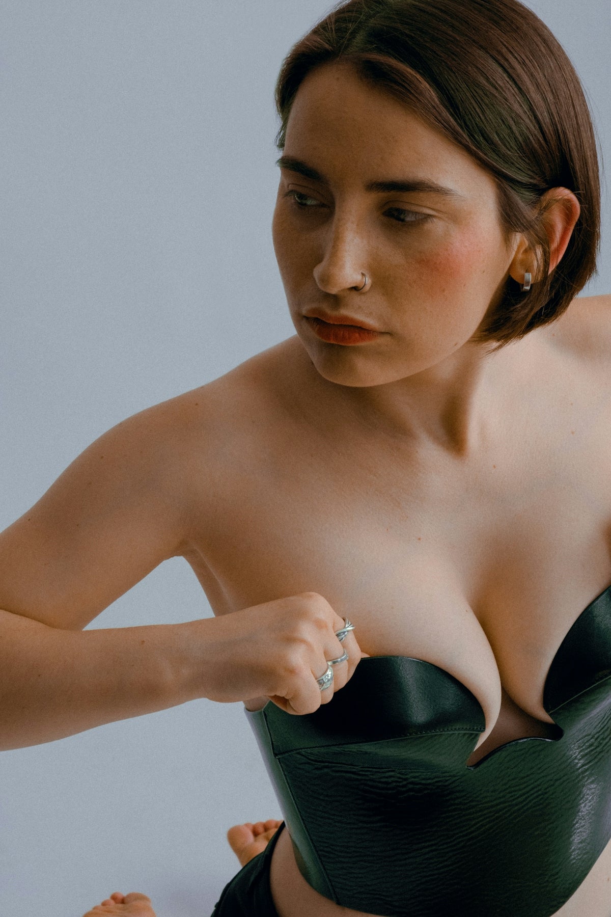 woman in black brassiere holding her hair