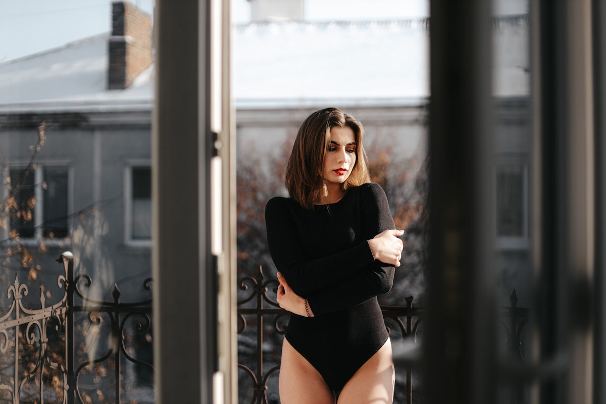 a woman standing in front of a window