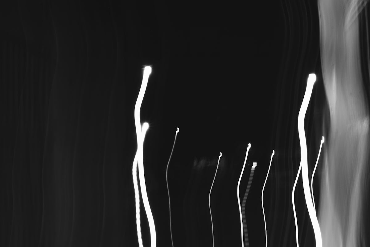 a black and white photo of street lights