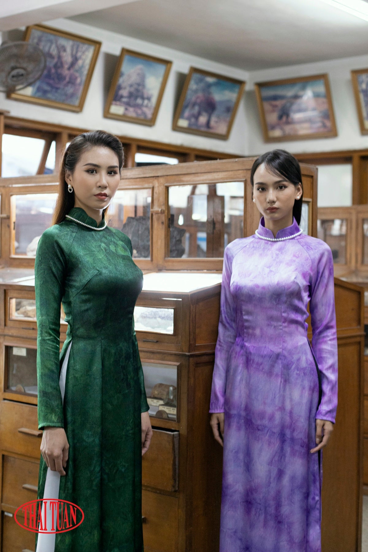 two women standing next to each other in a room