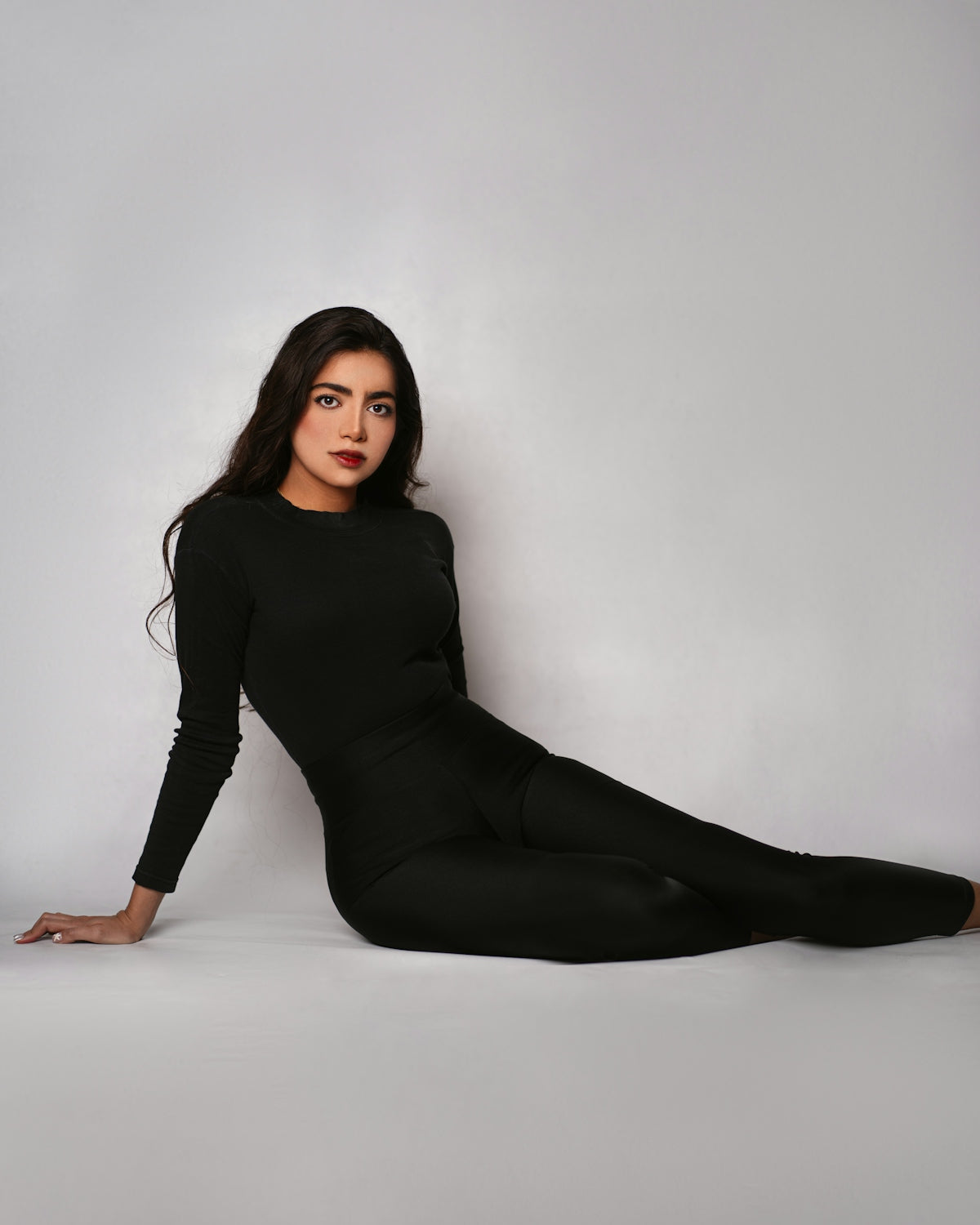 a woman in a black bodysuit posing for a picture