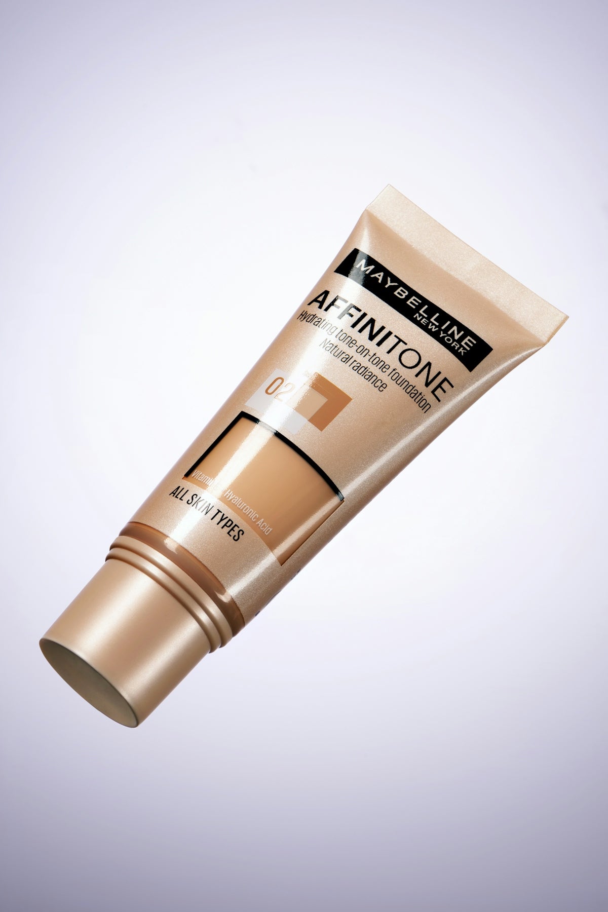 Maybelline affinitone foundation tube on white background