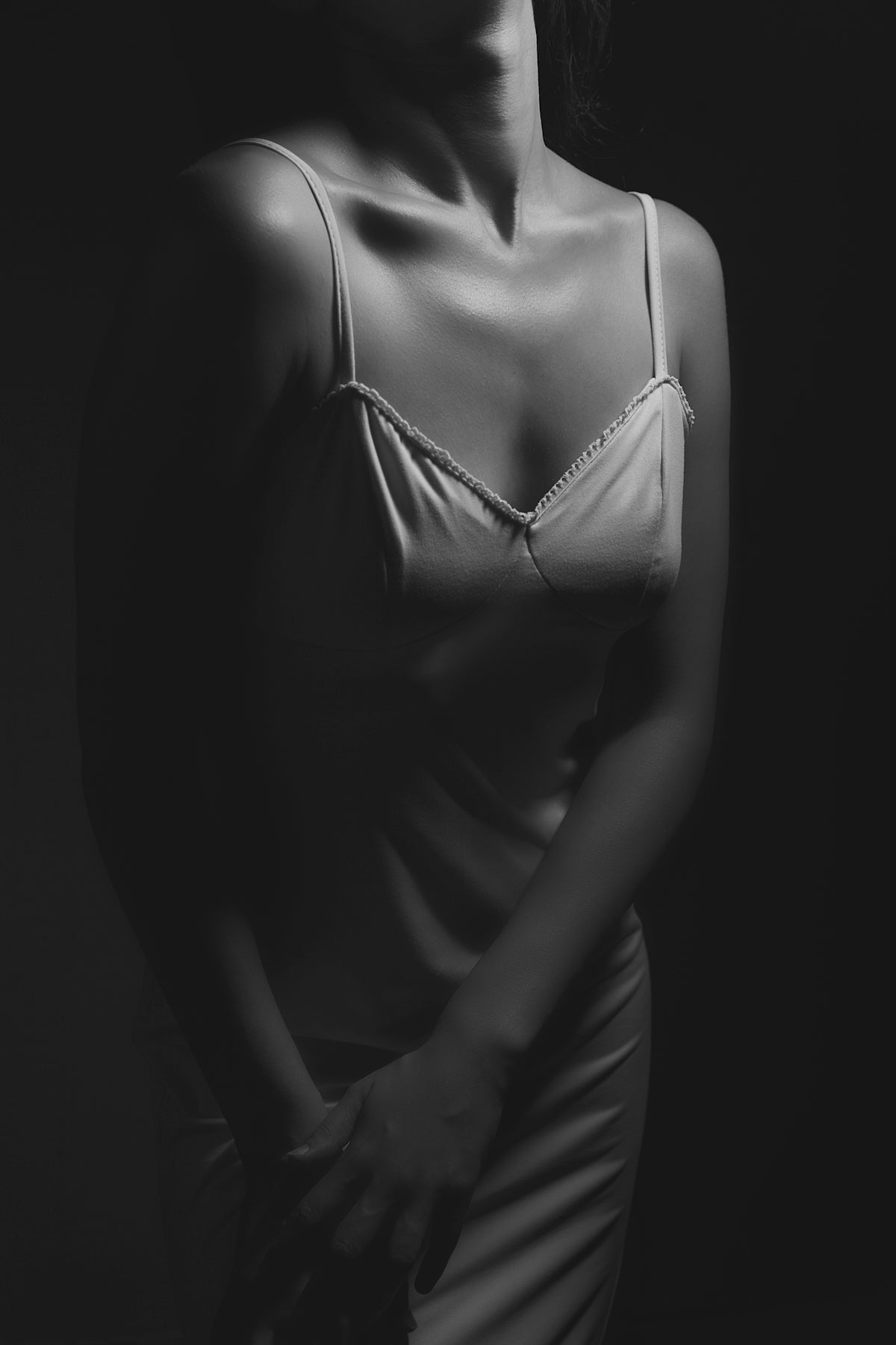 Woman in a slip dress against dark background