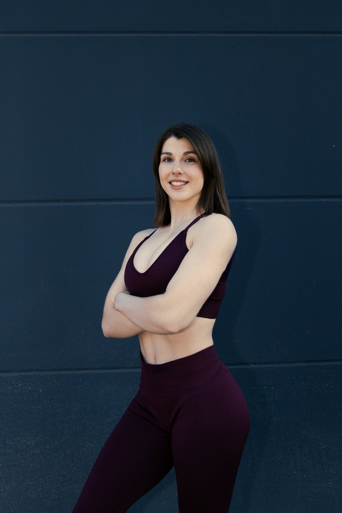 Fit woman in athletic wear with arms crossed