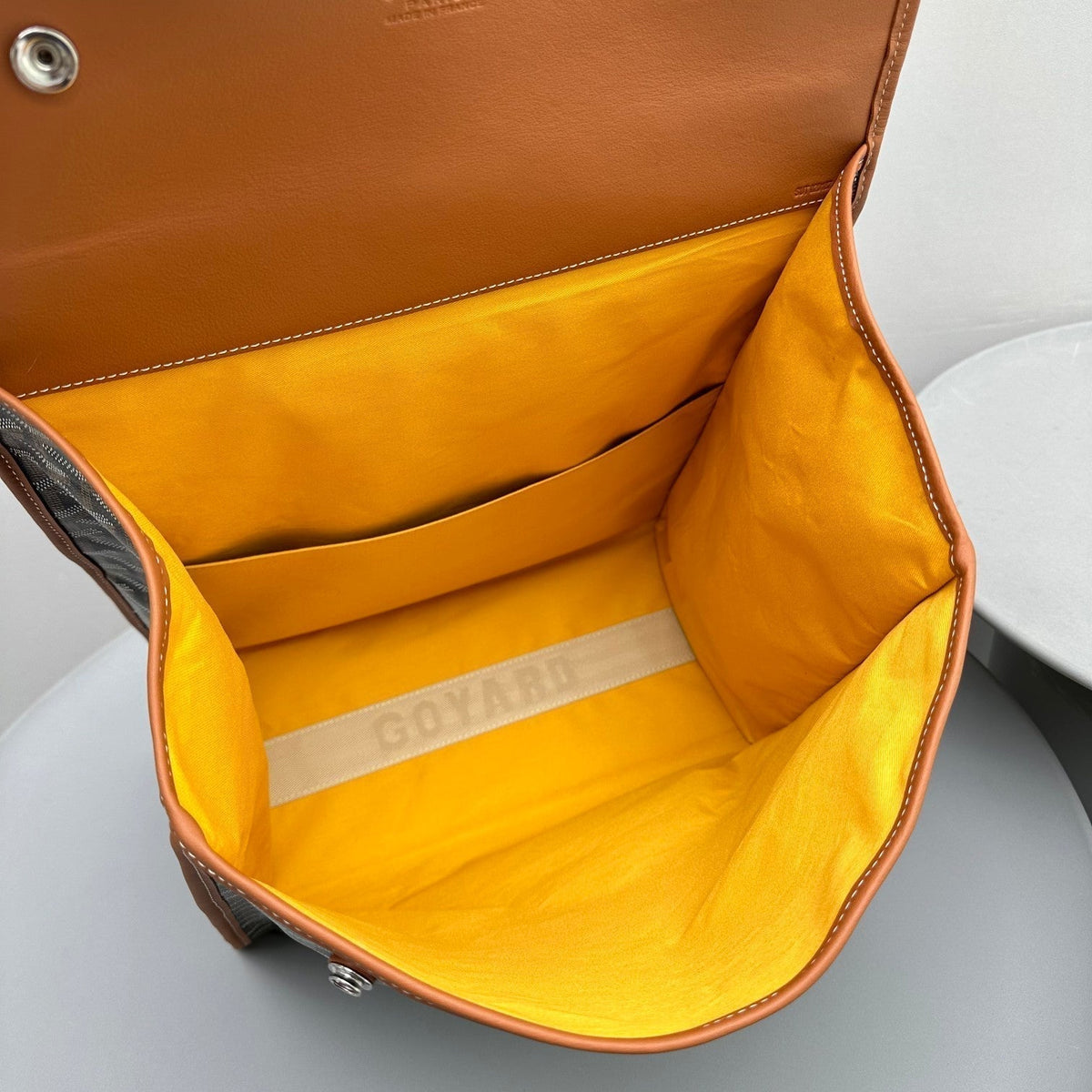 LEGER BACKPACK 37 IN BLACK GOYARDINE CANVAS WITH TAN CALFSKIN TRIM